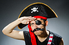 Funny pirate in dark studio | Stock Foto