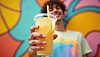 Young man holding refreshing lemonade against | Stock Illustration