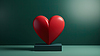 3D red heart sculpture on green background with sof | Stock Illustration