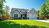 Beautiful suburban house with landscaped lawn, | Stock Foto
