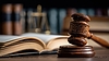 Wooden gavel and open law book on courtroom desk | Stock Foto