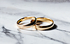 Gold wedding rings on marble background close up | Stock Foto