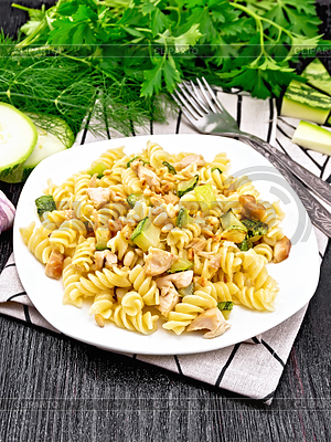 Fusilli with chicken and zucchini in plate on dark | High resolution stock photo |ID 6914050