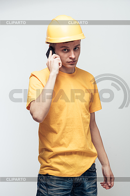 Worker in yellow helmet calling by phone | High resolution stock photo |ID 4108976