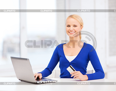 Smiling woman with laptop computer and credit card | High resolution stock photo |ID 4443728