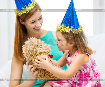 Mother and daughter in blue hats with teddy bear | High resolution stock photo |ID 4448762