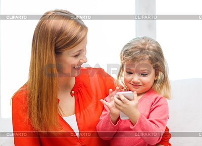 Happy mother and daughter with smartphone at home | High resolution stock photo |ID 4449030
