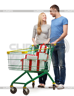 Smiling couple with shopping cart and gift boxes | High resolution stock photo |ID 4450303
