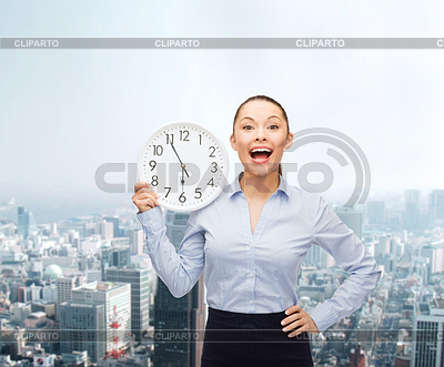 Attractive businesswoman with wall clock | High resolution stock photo |ID 4451670
