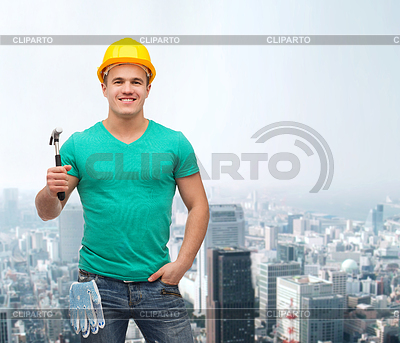 Smiling manual worker in helmet with hammer | High resolution stock photo |ID 4452017