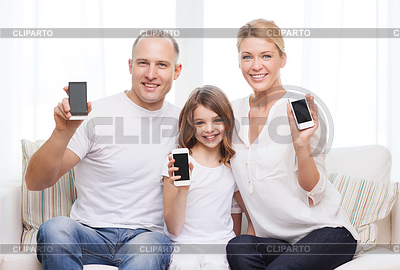 Parents and little girl with smartphones at home | High resolution stock photo |ID 4452650