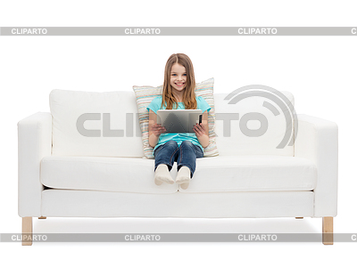 Little girl sitting on sofa with tablet pc comuter | High resolution stock photo |ID 4460556