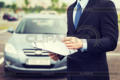Man with car documents outside | High resolution stock photo |ID 4463938