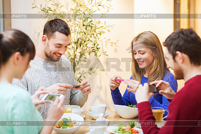 Amigos con los teléfonos inteligentes que toman el cuadro de los alimentos | Foto de alta resolución |ID 4871304