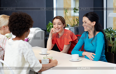 Happy young women drinking tea or coffee at cafe | High resolution stock photo |ID 4913336