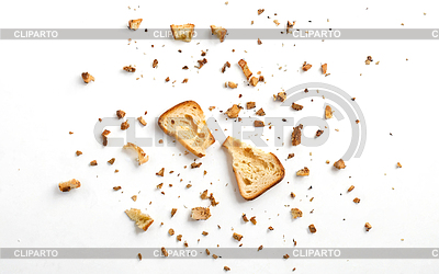 Scattered crumbs of roasted white bread on a white back | High resolution stock photo |ID 7585997